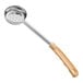 A close-up of a white Choice ivory perforated portion spoon.