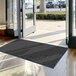 A large black Lavex Needle Rib indoor entrance mat.