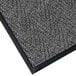 A close-up of a gray Lavex Chevron Rib entrance mat with black trim.