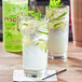 Two glasses of Rose's mojitos with ice and mint leaves.