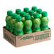 A cardboard box of 12 green plastic bottles of ReaLime lime juice with green caps.