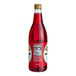 A close up of a Rose's 1 liter bottle of red liquid.