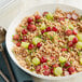A bowl of Del Destino semi-pearled farro with grapes and seeds.