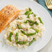 A plate of salmon and Riso Toro Carnaroli rice with asparagus on the side.