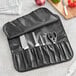A knife and scissors in a black Choice knife roll.