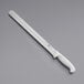 A white knife with a white handle and holes in the blade.