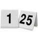 Two white Cal-Mil table tents with black numbers on them.