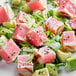 A plate of sushi grade ahi tuna portions with avocado and sesame seeds.