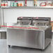 A Cecilware stainless steel electric countertop deep fryer with two large fry tanks and red handles.