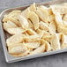 A tray of shrimp gyoza dumplings on a gray surface.