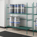 A Regency metal keg rack with kegs on it.