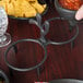 A black polyethylene holder with two molcajete bowls of salsa and tortilla chips.