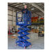A man standing on a blue Ballymore scissor lift with guard rails.