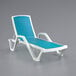 A white chaise lounge chair with a turquoise sling seat.