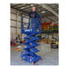 A man standing on a Ballymore blue scissor lift with guard rails.