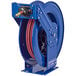 A blue Coxreels hose reel with a red hose attached.