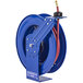 A blue metal Coxreels hose reel with a red hose attached.