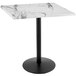 A white marble table with a black round base.