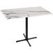 A white marble table with a black base.