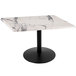 A white marble table with a black base.