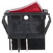 A close-up of a red Main Street Equipment on/off switch with a red rim.
