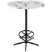 A round white marble Holland Bar Table with a black base.