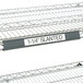 A gray Metro slanted plastic label holder on a shelf.