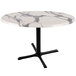 A white marble Holland Bar Table with a black cross base.