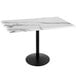 A white marble table with a black base.