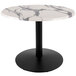 A white marble round table with a black round base.