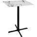A white marble table with a cross base.