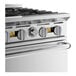 A stainless steel commercial gas range with multiple control knobs and a sturdy oven handle.
