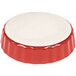 A red and white fluted china quiche dish.