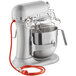 A silver KitchenAid 8 quart countertop mixer with wire guard.