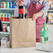 a person holding a brown bag