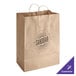 A brown paper bag with handles that says "Sundara" on it.