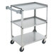 A stainless steel Vollrath utility cart with three shelves and black wheels.