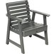 A Sequoia Coastal Teak faux wood outdoor arm chair with grey slats and armrests.