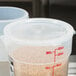 A translucent Cambro round plastic lid on a large container with pasta inside.