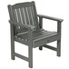 A Coastal Teak faux wood outdoor arm chair with gray armrests.