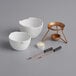 A white Boska ceramic bowl with a handle over a small white candle.