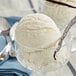a vanilla bean in a glass cup