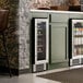 A dual temperature full glass door commercial wine cooler built into a kitchen cabinet.
