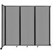 A light gray Versare wall-mounted room divider with a black frame.