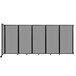 A light gray Versare wall-mounted room divider with black trim and several panels.