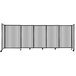 A clear poly Versare StraightWall sliding room divider with wheels.