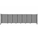 A light gray Versare Poly StraightWall sliding room divider with wheels.