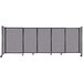 A Versare Cloud Gray StraightWall sliding room divider on wheels with black trim.