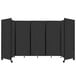 A black rectangular Versare room divider with white wheels.