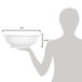 A woman holding a clear polycarbonate bowl.